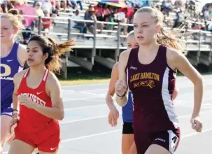  ?? The Sentinel-Record/Grace Brown ?? LAST RUN: Senior Josie Carson, right, ran for Lake Hamilton one last time Saturday in the Meet of Champions at Wolf Stadium. Carson, a signee for the Arkansas Razorbacks, ran second in the 1600-meter run and was a member of Lake Hamilton’s 4x400-meter...