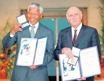  ?? AP ?? South African Deputy President F.W. de Klerk (right) and South African President Nelson Mandela pose with their Nobel Peace Prize Gold Medals and Diplomas in Oslo, Norway on December 10, 1993. For working together to end apartheid, de Klerk and Mandela were together awarded the Nobel Peace Prize.
