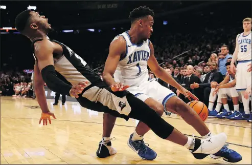  ?? GETTY IMAGES ?? Xavier’s Paul Scruggs (right) collides with Providence’s Kyron Cartwright. Xavier is thought to be the weakest No. 1 seed.