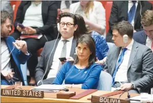  ?? AP PHOTO ?? American Ambassador to the United Nations Nikki Haley listens as Syrian Ambassador to the United Nations Bashar Ja’afari speaks after a vote on a resolution during a Security Council meeting on the situation in Syria, Saturday.