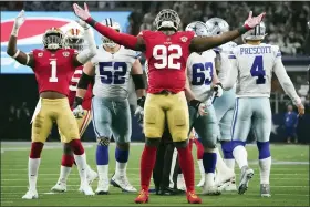  ?? SMILEY N. POOL — THE DALLAS MORNING NEWS VIA AP ?? San Francisco 49ers defensive end Charles Omenihu (92) celebrates after sacking Dallas Cowboys quarterbac­k Dak Prescott (4) during the second half of an NFL wild-card playoff football game in Arlington, Texas, Sunday, Jan. 16, 2022.