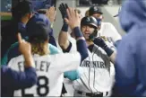  ?? AP photo ?? The Mariners’ Mitch Haniger celebrates in the dugout after hitting a solo home run in the seventh inning Tuesday.