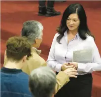  ?? ?? Lake County District 5 Councilwom­an Christine Cid, right, greets wellwisher­s after the ceremony, which was held for anyone in the party who had recently been elected to office.