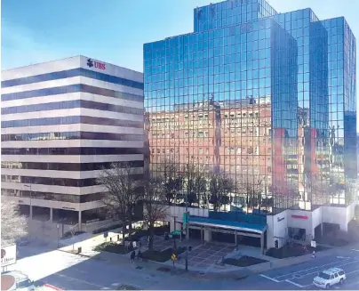  ?? STAFF PHOTOS BY DAVE FLESSNER ?? The 12-story Tallan Financial Center at M.L. King Boulevard and Carter Street and the adjacent 10-story Krystal Building at M.L. King Boulevard and Broad Street have been purchased by Life Care Centers founder Forrest Preston. The two downtown offices...