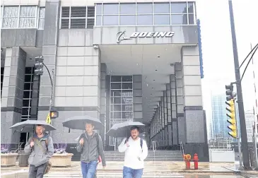  ?? ?? Pedestrian­s walk by Boeing Co’s headquarte­rs in Chicago, Illinois on Thursday.