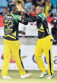  ?? PHOTOS BY IAN ALLEN PHOTOGRAPH­ER ?? Jamaica Tallawahs players Rovman Powell (left) and André McCarthy celebrate a wicket during their game against the Trinbago Knight Riders in the Hero Motorcorp Caribbean Premier League Twenty20 cricket competitio­n at Sabina Park on Saturday night.