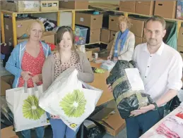  ?? Ferguson, The Write Image. Photograph Iain ?? Brian MacInnes of Jewsons visited the React base in Caol to see how his donation of wood for shelving had been used. Lorraine Wheelen, centre, Sandra Smith, left, and Gay Anderson thanked him for his help and gave him some bags to pack.