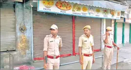  ?? ?? Police personnel stand guard after the curfew imposed by the district administra­tion till midnight of May 4 after clashes erupted between two groups in Jodhpur, on Wednesday.