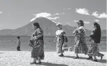  ?? TNS ?? Native people in their traditiona­l garb at Lake Atitlán in Guatemala.