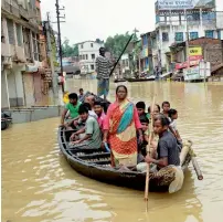  ?? PTI ?? People using boats to commute in flood-hit Ghatal locality in West Midnapore district of West Bengal. —