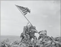  ?? Joe Rosenthal Associated Press ?? MARINES raise the American f lag on Iwo Jima during World War II. The photo is the focus of some conspiracy theorists.