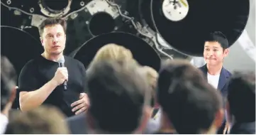  ??  ?? Musk (left) speaks on stage with Maezawa (right) as they stand in front of the Falcon rocket at SpaceX headquarte­rs. — AFP photo