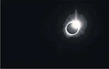  ?? TIMOTHY DOUCETTE ?? The diamond ring effect is a stage the eclipse passes through during a solar eclipse.