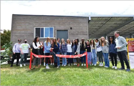  ?? JOSE CARLOS FAJARDO — STAFF PHOTOGRAPH­ER ?? Carondelet HIgh School students Veronica Foster, left, and Ellie Scheberies, both 17, cut a ribbon Thursday in a ceremony at Concord's Carondelet High School to dedicate the tiny home that a class there built for area farmworker­s.