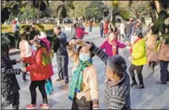  ??  ?? Elderly dance in Wuhan as the city marks the first anniversar­y of the day China confirmed its first death from the COVID-19 coronaviru­s.