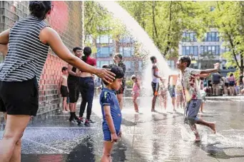  ?? Chris Sweda/Tribune News Service ?? Anchal Khanna of Chicago’s Lakeview neighborho­od touches her son Veer Roy as the 2-year-old considers the landscape of Millennium Park’s Crown Fountain during a heat wave on June 14.