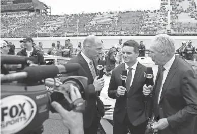  ?? CARLOS OSORIO/AP ?? Fox Sports broadcaste­rs Adam Alexander, from left, Jeff Gordon and Darrell Waltrip are shown on pit row before a 2019 NASCAR Cup Series race at Michigan Internatio­nal Speedway.