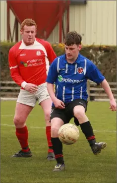  ??  ?? Ian Bradley of Raheen closes in on Ciarán Sheridan of Gorey Rangers during their Division 3 match in Ramstown on Sunday.