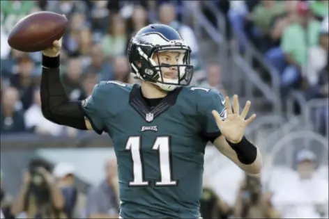  ?? CHRIS SZAGOLA — THE ASSOCIATED PRESS ?? Philadelph­ia Eagles’ Carson Wentz passes during the first half of an NFL football game against the Pittsburgh Steelers, Sunday in Philadelph­ia.