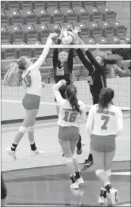  ?? MARK HUMPHREY ENTERPRISE-LEADER ?? Farmington junior Brittany Pittman attacks at the net against the attempted block of Gravette’s Allie Callahan and Olivia Perry while Farmington’s Eliza Ball and Anthea Jones stand ready to help. The Lady Cardinals defeated Gravette 25-23, 25-18, 25-17 on Sept. 6 at Cardinal Arena.