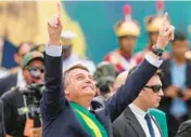  ?? ERALDO PERES/AP ?? Brazil’s President Jair Bolsonaro points up Wednesday during a military parade in Brasilia marking the bicentenni­al of the country’s independen­ce from Portugal.