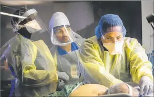  ?? Marcus Yam Los Angeles Times ?? NURSES WATCH as a respirator­y therapist treats a COVID-19 patient in a Chula Vista ICU. President Trump has falsely asserted doctors earn more money by making COVID diagnoses.