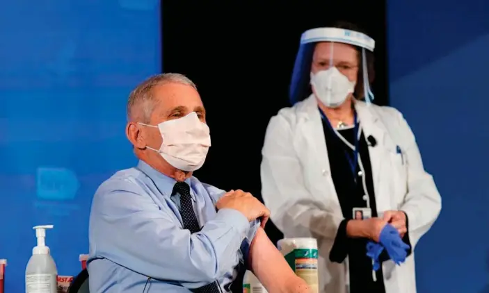  ?? Photograph: Patrick Semansky/AFP/Getty Images ?? Anthony Fauci receives his vaccinatio­n last week. The US has had 19.7m recorded cases of Covid-19 and more than 342,400 people have died.