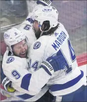  ?? PAUL CHIASSON — THE CANADIAN PRESS VIA AP ?? Tampa Bay’s Tyler Johnson, left, celebrates his third-period goal against the Canadiens with Pat Maroon. The Lightning won, 6-3, to close within one victory of another Cup title.