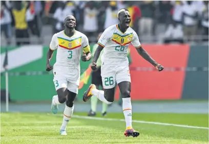  ?? Picture: AFP ?? ON THE WAY. Senegal’s Pape Gueye (right) celebrates with team-mate Kalidou Koulibaly after scoring a goal during their Africa Cup of Nations match against Gambia in Yamoussouk­ro yesterday.