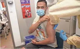  ?? MARY ALTAFFER/AP ?? A patient is inoculated with the monkeypox vaccine during a vaccinatio­n clinic at the OASIS Wellness Center last week in New York.