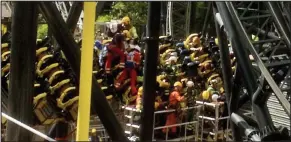  ??  ?? Collision: Rescuers help the injured in last year’s Smiler crash