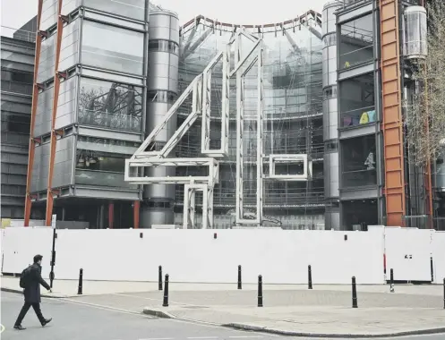  ?? ?? 0 A pedestrian crosses the street in front of the Channel 4 headquarte­rs in London, as the government plans to privatise the channel