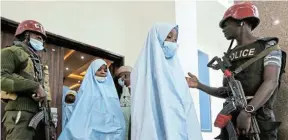  ?? Picture: AFOLABI SOTUNDE/REUTERS ?? FREED: Girls who were kidnapped from a boarding school in the northwest Nigerian state of Zamfara head for a medical check-up after their release in Zamfara, Nigeria, yesterday