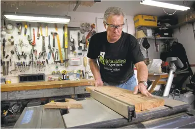  ?? PATRICK TEHAN/STAFF PHOTOS ?? RalphWiggi­nton cuts wood at his Santa Clara home. The Santa Clara County Office of Education has placed Wigginton on unpaid leave for talking to a reporter about disputes over management of a project to build tiny houses for homeless people.