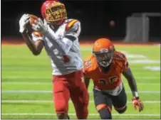  ?? PETE BANNAN — DIGITAL FIRST MEDIA ?? Haverford receiver Carington Hooks hauls in a touchdown in the third quarter against Marple Newtown Saturday night, one of three thrown by quarterbac­k Jake Ruane in a dominant 35-0 win over Marple Newtown.