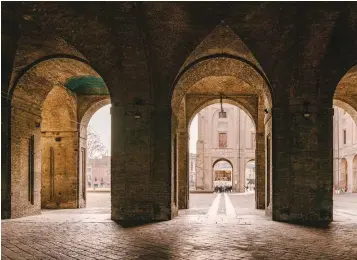 ??  ?? Clockwise from
right: A view through an arched portico at Palazzo della Pilotta; Massimo Spigaroli, chef and owner of Antica Corte Pallavicin­a; the cozy interiors of Hosteria del Maiale; the approach to the Palazzo della Pilotta complex.