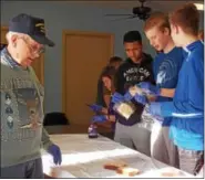  ??  ?? Several eighth-grade Exeter students came out to help the Legion members make the bagged lunches.