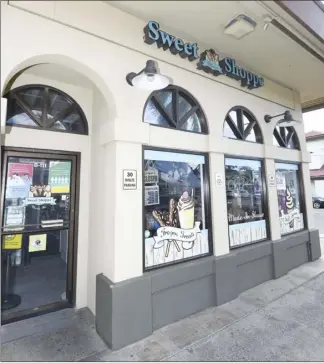  ?? The Maui News / MATTHEW THAYER photo ?? The Maui Sweet Shoppe is closed Friday afternoon at Kukui Mall in Kihei. The business’ owners are seeking donations to help make repairs to the shop in hopes of keeping it open for their 8-year-old son to work in some day.