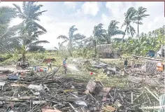  ?? ?? Residents walk past homes destroyed by Super Typhoon Rai in Eastern Samar province of the Philippine­s in December 2021. Climate change is leading to more extreme weather events and many countries in Asia are especially vulnerable.