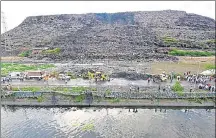  ?? PTI FILE ?? A massive chunk of Delhi’s Ghazipur landfill fell into a canal running alongside on September 1, killing two people and washing away four vehicles on the adjoining road.