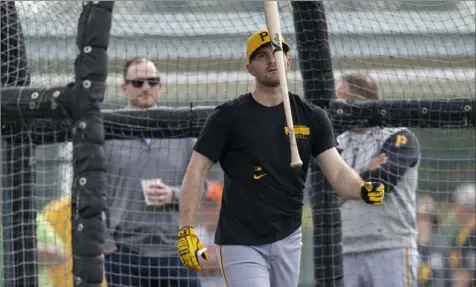  ?? Benjamin B. Braun/Post-Gazette photos ?? Pirates catcher Jason Delay flips a bat after hitting at Pirate City during spring training on Feb. 16 in Bradenton, Fla. Delay made the opening day roster.