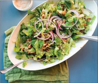  ?? The Associated Press ?? This roasted cauliflowe­r and chickpea salad tossed with garlic-tahini dressing is from a recipe by Katie Workman.