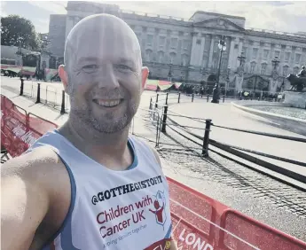  ?? ?? Chris in front of Buckingham Palace while taking part in the London Marathon.