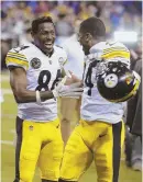  ?? AP PHOTO ?? IT’S A WIN: Antonio Brown and Coty Sensabaugh celebrate the Steelers’ win.