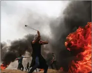  ?? IANS ?? A Palestinia­n protester hurls stones at Israeli troops during clashes on the Gaza-Israel border, on Friday.