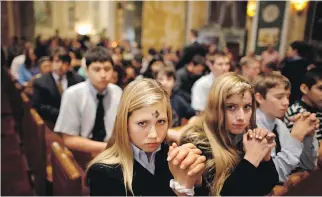  ?? CHIP SOMODEVILL­A/GETTY IMAGES FILES ?? Marked with a cross of black ash on the forehead, Catholics pray during an Ash Wednesday Mass at the Cathedral of St. Matthew the Apostle in Washington, D.C.