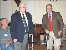  ?? Diane Wagner / RN-T ?? Floyd County Commission­er Wright Bagby (right) laughingly offers Superior Court Administra­tor Phil Hart a walker as Hart is called to the front of the commission chambers Tuesday to receive a pin marking his 35 years of service.