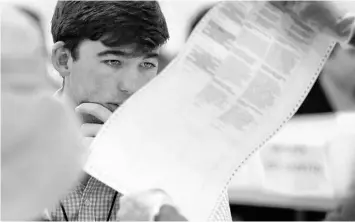  ?? WILFREDO LEE/AP ?? An observer looks at a ballot during a recount in 2018 at the Broward County Supervisor of Elections office in Lauderhill.