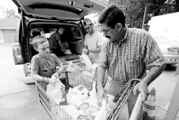  ?? AP PHOTOS ?? In this Thursday, August 8, 2019, photo, Pastor Hugo Villegas (right) and his son, Pablo Villegas (second from right), assist Cade Vowell (left) and his sister, Addison Vowell, second from left, unload donated items for the pantry at the Carlisle Crisis Center in Forest, Mississipp­i The centre, a ministry of Scott County Baptist Associatio­n, says it will need more food items to help out the families affected by the fallout of Wednesday’s raid by US immigratio­n officials at poultry plants Koch Foods and PH Foods in neighbouri­ng Morton.