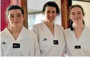  ?? JOHN VELVIN/STUFF ?? Clare, Bronwen and Kate Pepperell all gained the rank of black belt on Saturday.